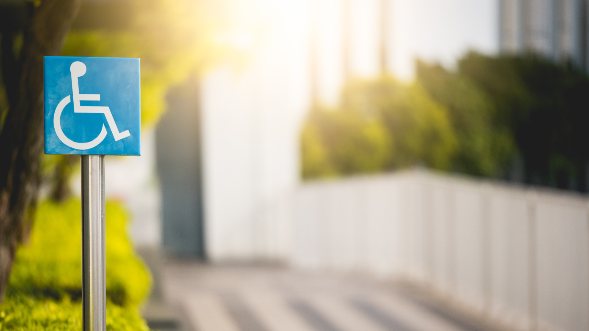Disabled sign or handicap symbol at park In the urban city with sun light.