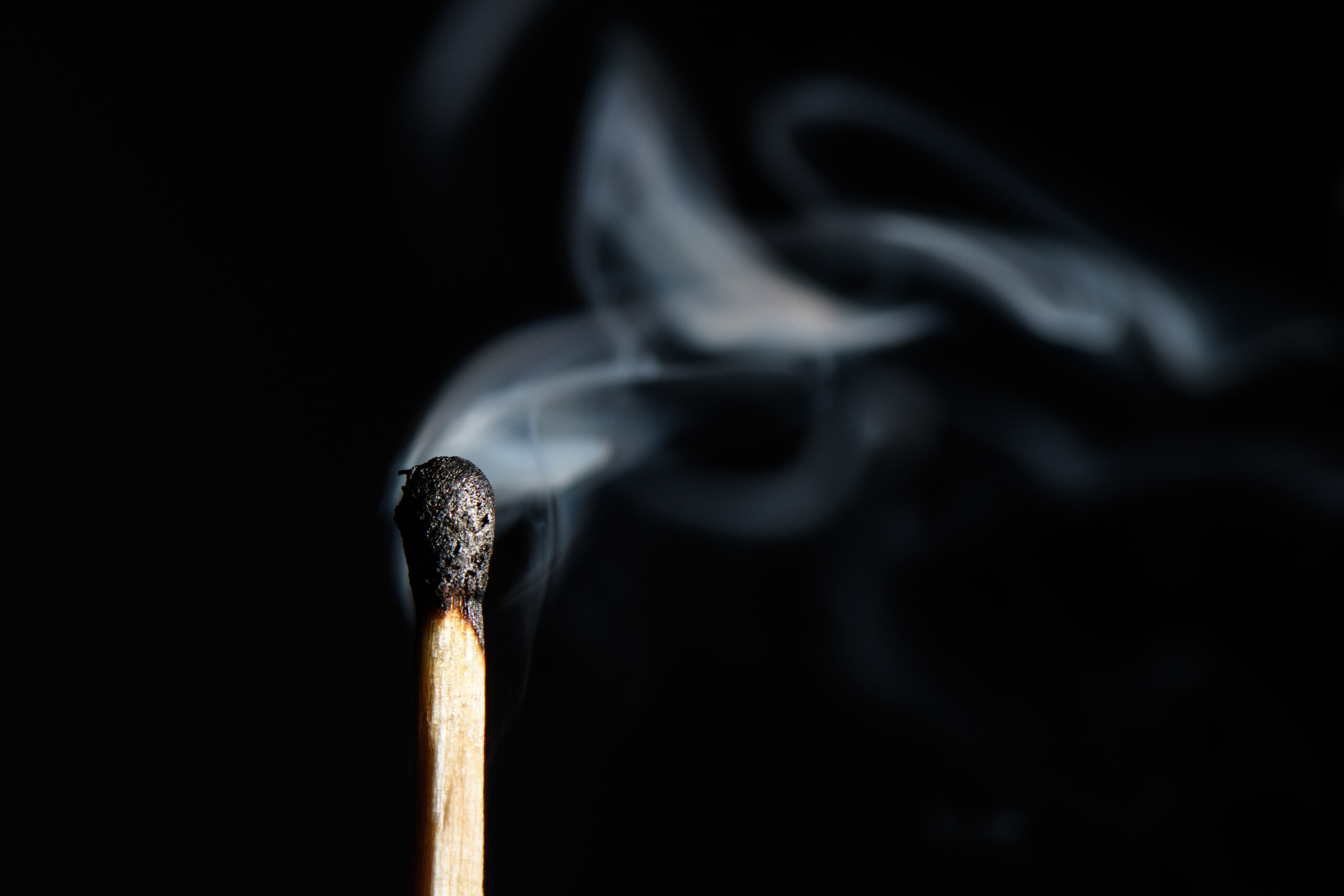 extinguished match liberally let smoke isolated on black background